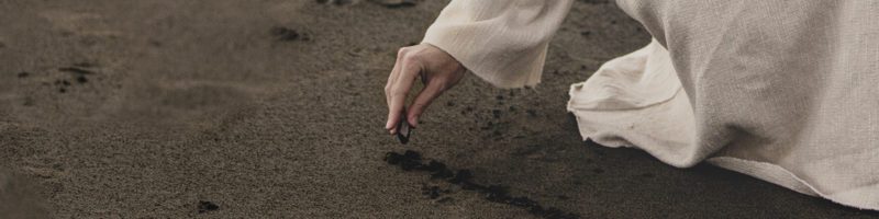 Jesus drawing in the sand