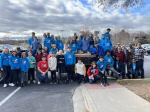 The Spencerville Polar Bear Pathfinder Club sitting on a trailer of food collected in 2024.