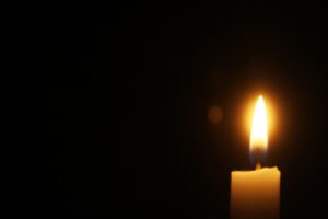 lit candle on a black background