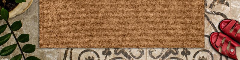 a door mat in front of a wooden door